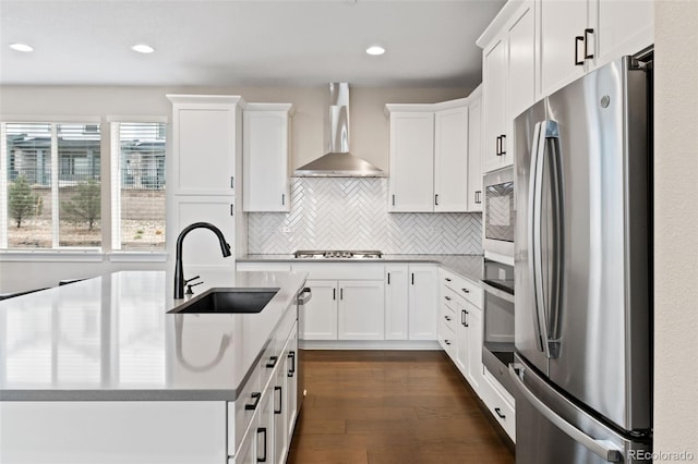 11350 W Grand Ave, Littleton, CO 80127 - kitchen with wall chimney range hood, backsplash, white cabinets, appliances with stainless steel finishes, and a sink