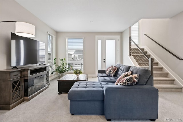 11350 W Grand Ave, Littleton, CO 80127 - carpeted living area with baseboards, a glass covered fireplace, and stairway