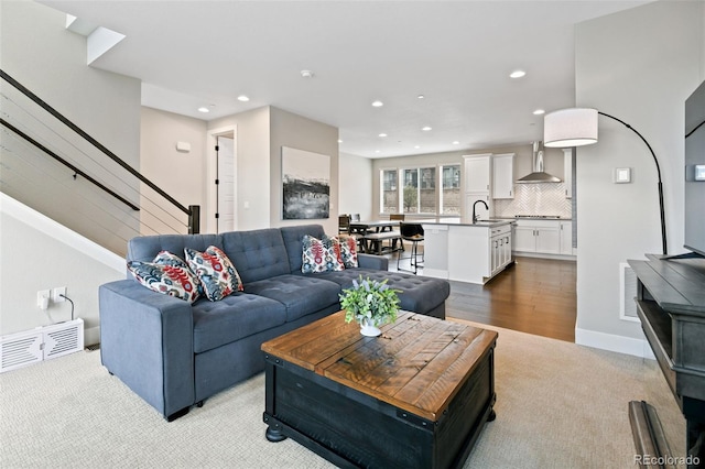 11350 W Grand Ave, Littleton, CO 80127 - living area with light carpet, recessed lighting, stairway, and visible vents