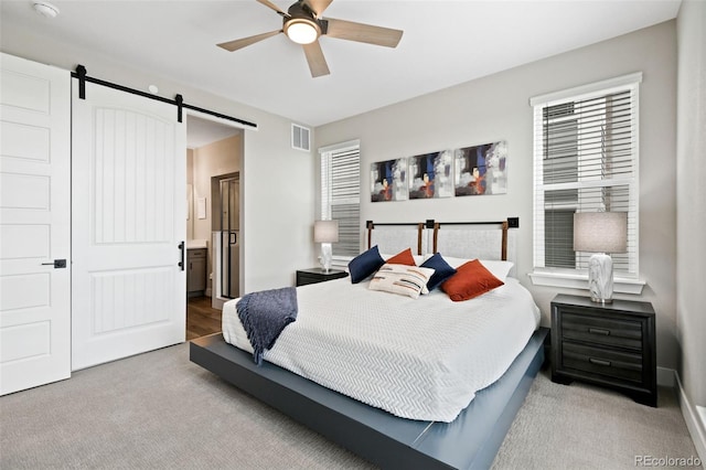 11350 W Grand Ave, Littleton, CO 80127 - bedroom with a barn door, carpet, visible vents, and ensuite bathroom