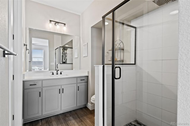 11350 W Grand Ave, Littleton, CO 80127 - full bathroom with toilet, a stall shower, wood finished floors, and vanity