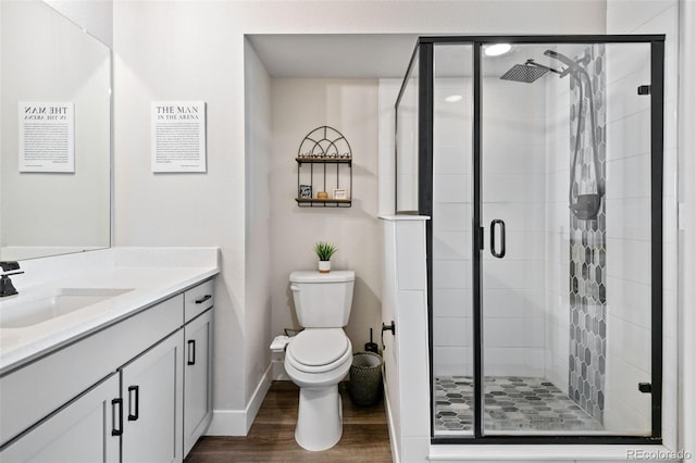 11350 W Grand Ave, Littleton, CO 80127 - full bathroom with toilet, a stall shower, and wood finished floors