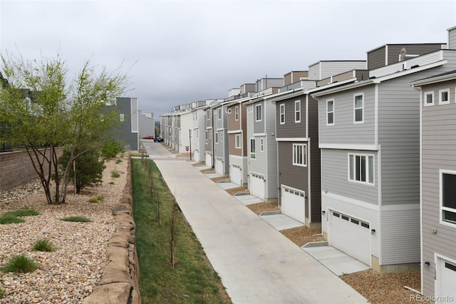 11350 W Grand Ave, Littleton, CO 80127 - surrounding community with an attached garage, a residential view, and driveway
