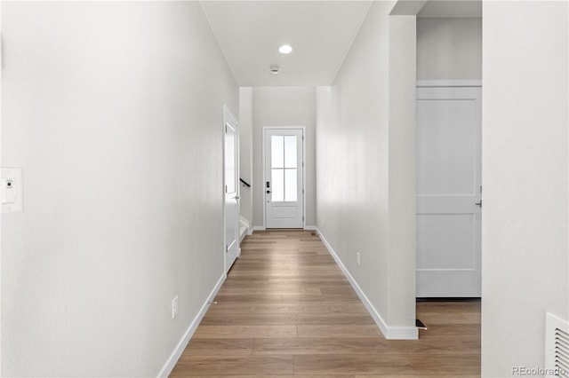 corridor with light hardwood / wood-style floors