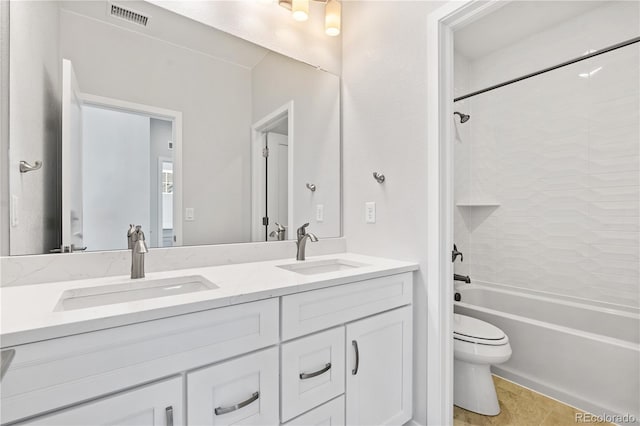 full bathroom featuring toilet, vanity, tile patterned floors, and tiled shower / bath