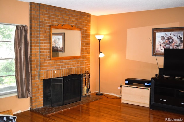 3548 S Hillcrest Dr Unit 2, Denver, CO 80237 - unfurnished living room with a fireplace, wood finished floors, and healthy amount of natural light