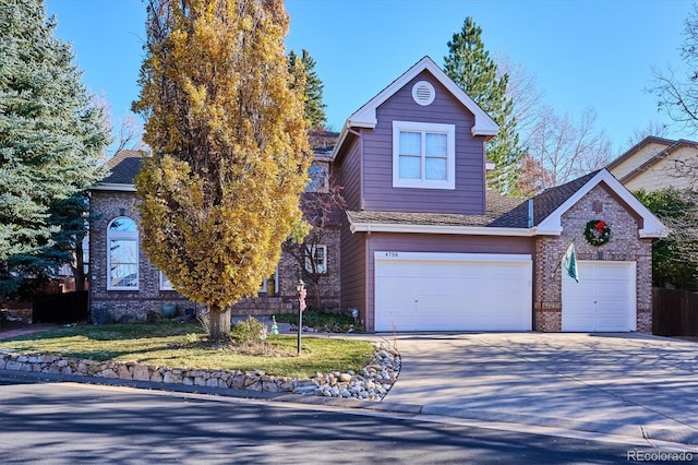 front facade featuring a front yard and a garage