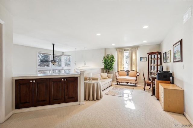 living room with ceiling fan and light colored carpet