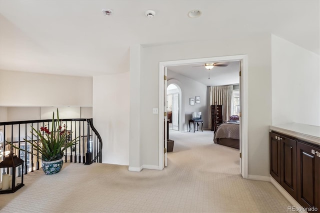 hall with light colored carpet