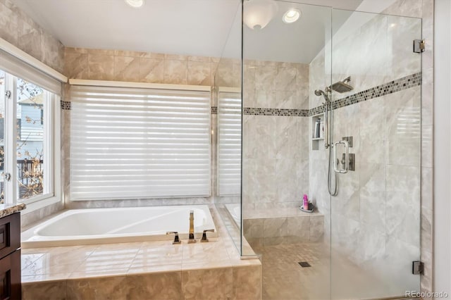 bathroom featuring shower with separate bathtub and vanity