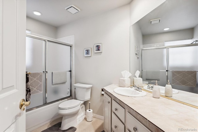 full bathroom with vanity, bath / shower combo with glass door, and toilet