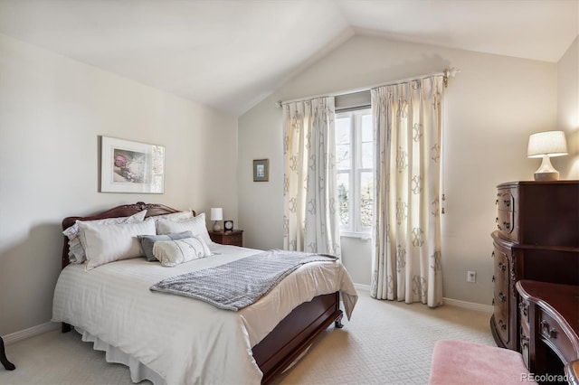 bedroom with light colored carpet and vaulted ceiling