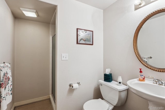 bathroom with sink, an enclosed shower, and toilet