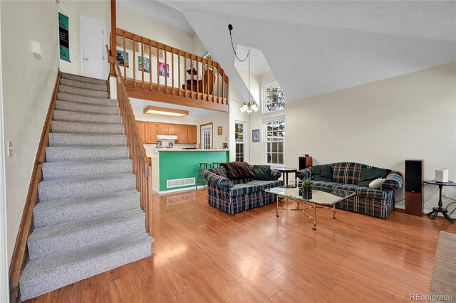 14110 E Dickinson Dr Unit A, Aurora, CO 80014 - living room with high vaulted ceiling, light wood-style floors, and stairs