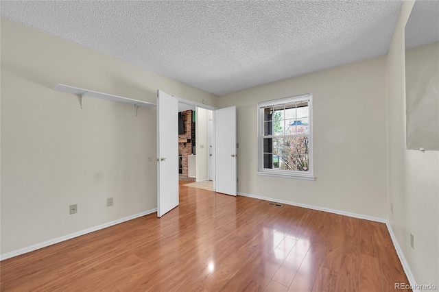 14110 E Dickinson Dr Unit A, Aurora, CO 80014 - unfurnished bedroom with wood finished floors, a textured ceiling, and baseboards
