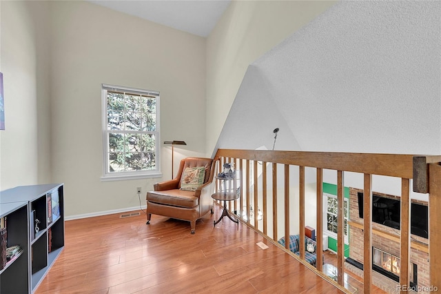 14110 E Dickinson Dr Unit A, Aurora, CO 80014 - sitting room featuring wood finished floors, baseboards, and high vaulted ceiling
