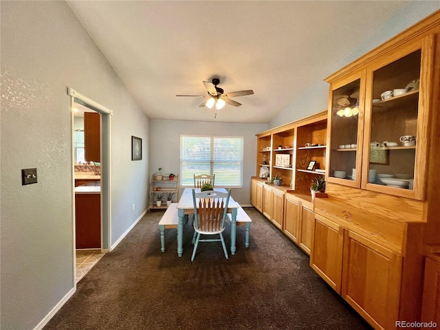 carpeted dining area featuring lofted ceiling and ceiling fan