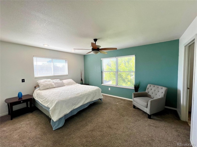 bedroom with a textured ceiling, carpet, and ceiling fan