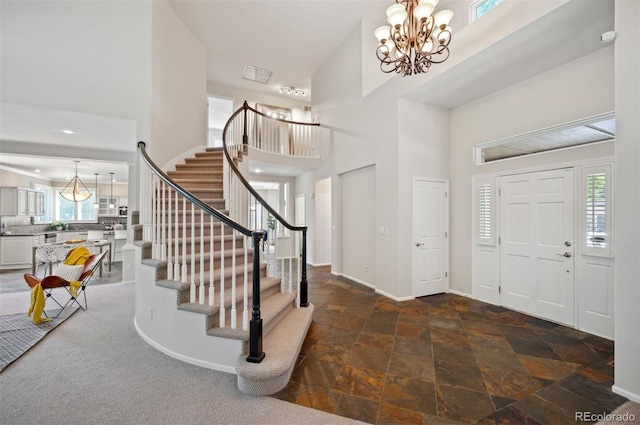 16690 Amberstone Way, Parker, CO 80134 - entryway with a high ceiling, a chandelier, stairway, and stone finish flooring