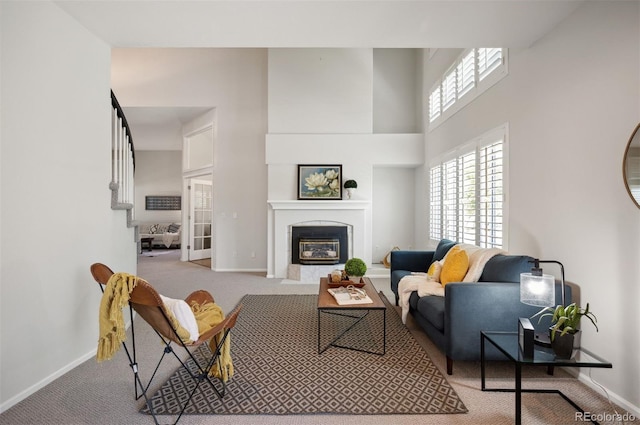 16690 Amberstone Way, Parker, CO 80134 - carpeted living area featuring a tiled fireplace and a towering ceiling