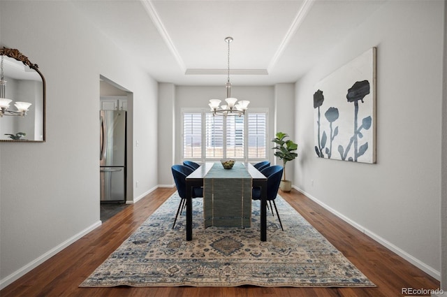 16690 Amberstone Way, Parker, CO 80134 - dining space featuring a chandelier, a raised ceiling, and dark wood-style flooring