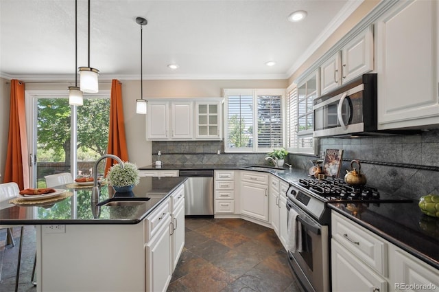 16690 Amberstone Way, Parker, CO 80134 - kitchen with appliances with stainless steel finishes, stone tile flooring, crown molding, decorative backsplash, and white cabinetry