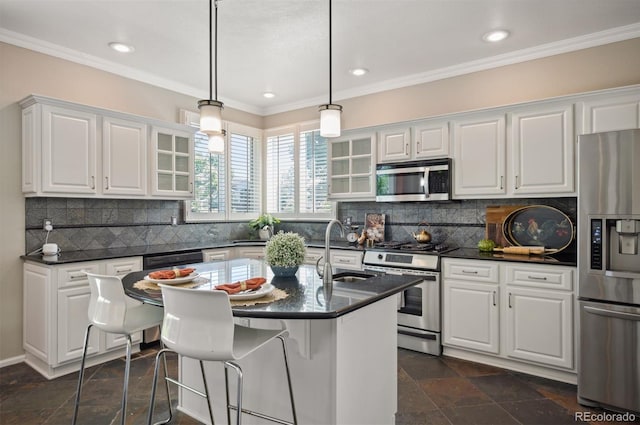 16690 Amberstone Way, Parker, CO 80134 - kitchen featuring appliances with stainless steel finishes, glass insert cabinets, crown molding, white cabinetry, and stone tile floors