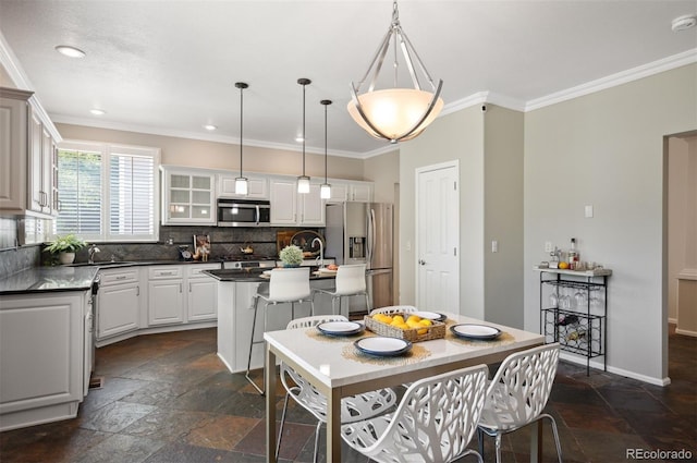 16690 Amberstone Way, Parker, CO 80134 - dining room with stone tile floors, crown molding, and recessed lighting