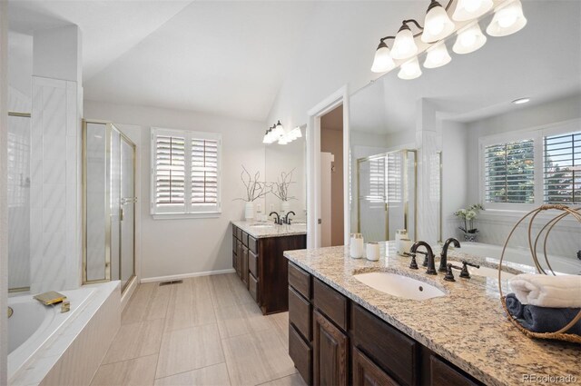 16690 Amberstone Way, Parker, CO 80134 - full bath with two vanities, a stall shower, healthy amount of natural light, and vaulted ceiling