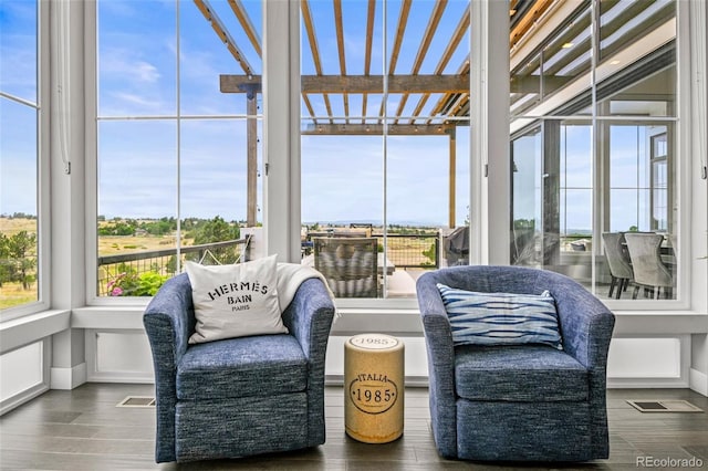 sunroom / solarium with a water view