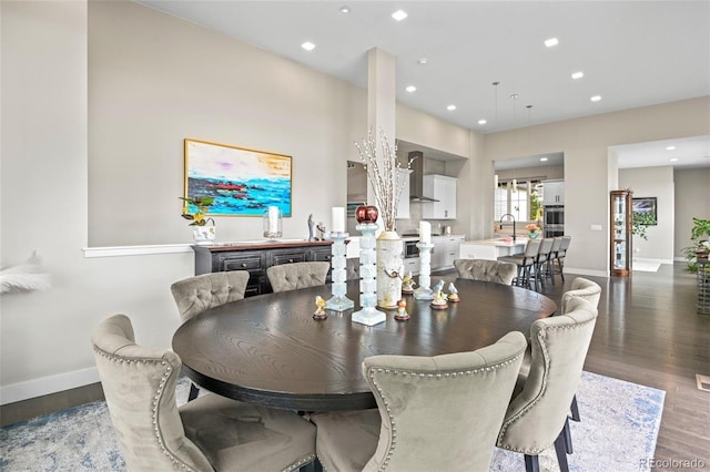 dining room featuring sink and dark hardwood / wood-style flooring