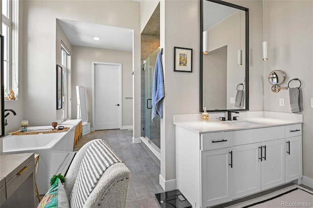 bathroom featuring a shower with door, tile patterned floors, and vanity