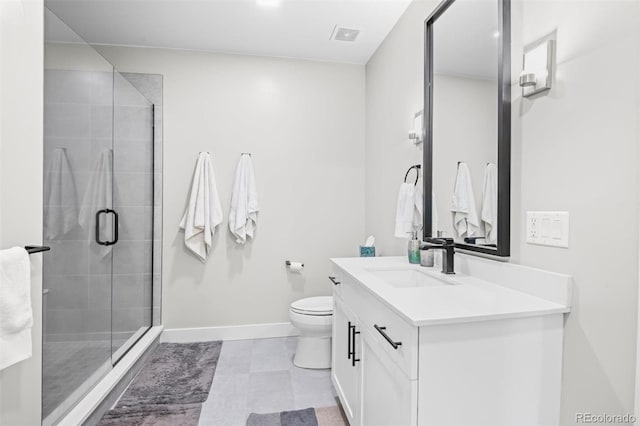 bathroom featuring toilet, a shower with shower door, and vanity