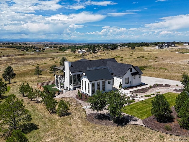 birds eye view of property with a rural view