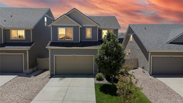 19000 E 55th Ave, Denver, CO 80249 - craftsman-style home featuring concrete driveway, a garage, roof with shingles, and board and batten siding