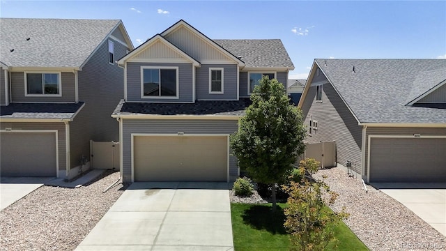 19000 E 55th Ave, Denver, CO 80249 - craftsman inspired home featuring driveway, board and batten siding, an attached garage, and a shingled roof