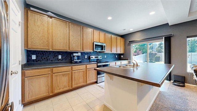 19000 E 55th Ave, Denver, CO 80249 - kitchen featuring stainless steel appliances, healthy amount of natural light, backsplash, dark countertops, and recessed lighting