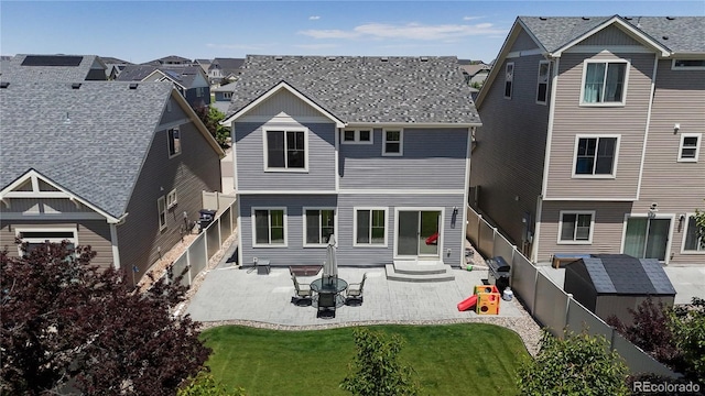 19000 E 55th Ave, Denver, CO 80249 - back of property with a patio, a residential view, a fenced backyard, and a shingled roof