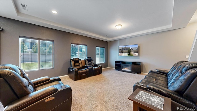 19000 E 55th Ave, Denver, CO 80249 - carpeted living area featuring a tray ceiling, a glass covered fireplace, and recessed lighting