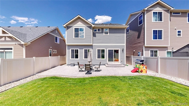 19000 E 55th Ave, Denver, CO 80249 - rear view of house featuring a fenced backyard and a patio area