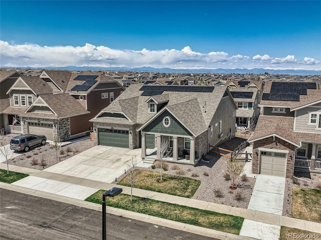 view of front of property featuring a garage and a mountain view