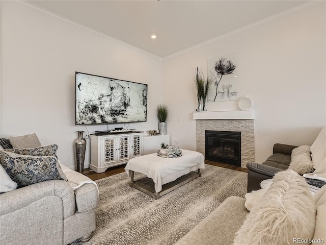 living room with hardwood / wood-style floors, crown molding, and a fireplace