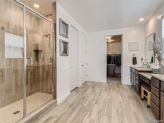 bathroom featuring vanity, hardwood / wood-style floors, and walk in shower