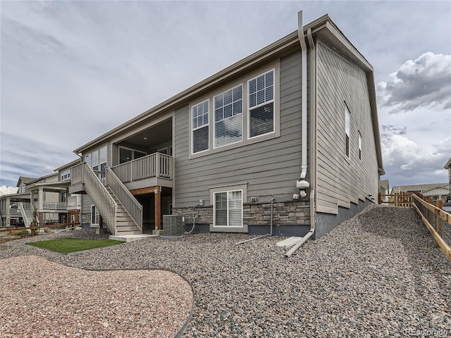 rear view of property with central air condition unit