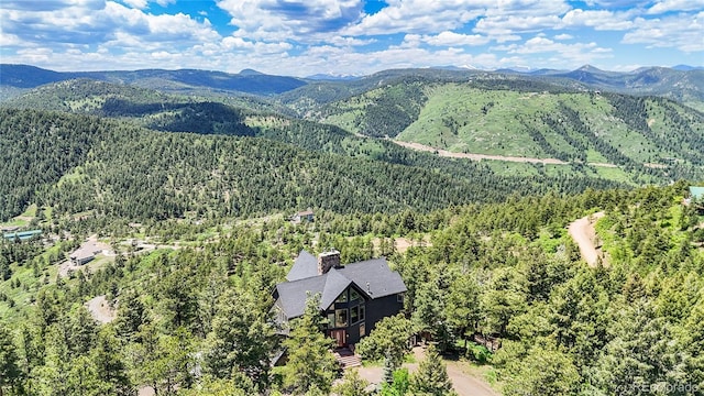 14980 Elk Mountain Trl, Littleton, CO 80127 - drone / aerial view of a heavily wooded area and a mountainous background