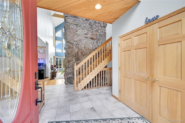 14980 Elk Mountain Trl, Littleton, CO 80127 - foyer entrance with stairs, wooden ceiling, and light tile patterned floors