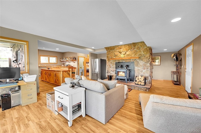14980 Elk Mountain Trl, Littleton, CO 80127 - living room with light wood finished floors, recessed lighting, and a wood stove
