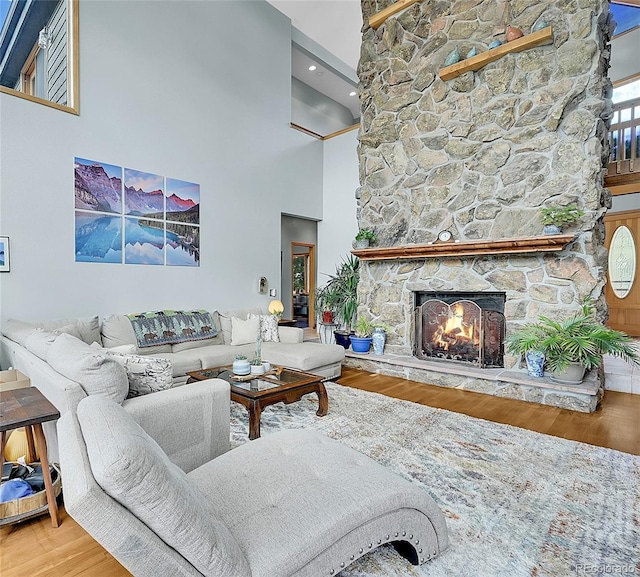 14980 Elk Mountain Trl, Littleton, CO 80127 - living room with wood finished floors, a high ceiling, and a fireplace