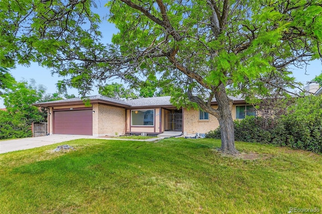 2122 S Yank Way, Lakewood, CO 80228 - view of front of property featuring a garage, concrete driveway, a front yard, and brick siding