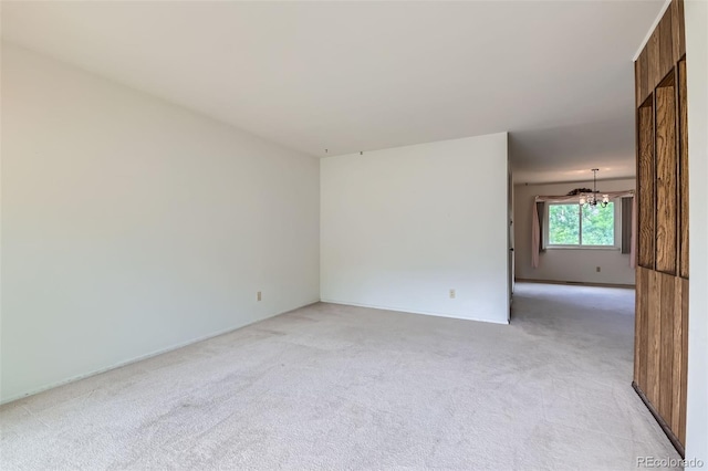 2122 S Yank Way, Lakewood, CO 80228 - empty room featuring light colored carpet and a chandelier